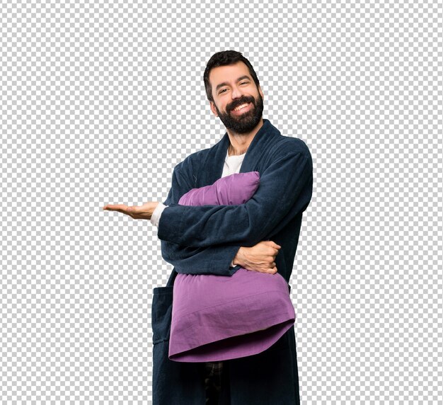 Man with beard in pajamas presenting an idea while looking smiling towards