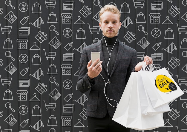 PSD man with mobile in hand and shopping bags