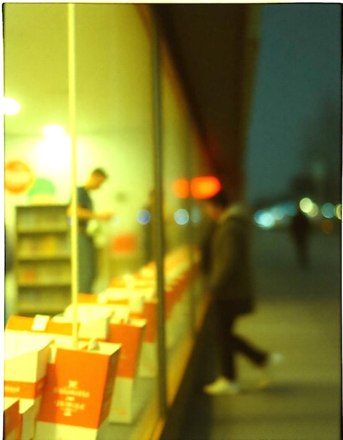 a man and a woman are standing in front of a store with a sign that says sale