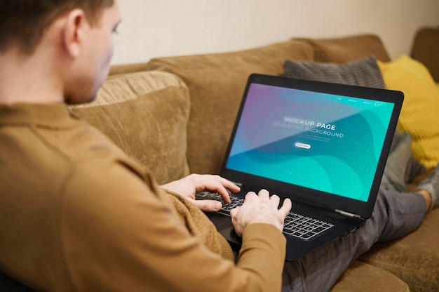 Man working on laptop from home while sitting on the couch