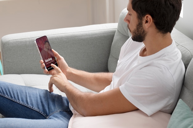 Medium shot man holding smartphone