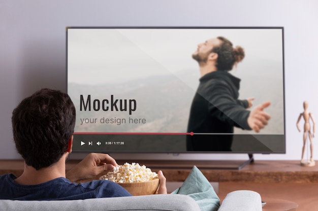 Medium shot man watching movie on tv