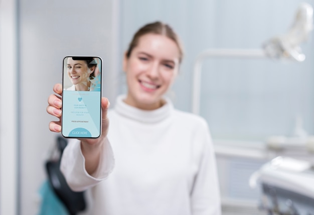 Medium shot woman holding a smartphone