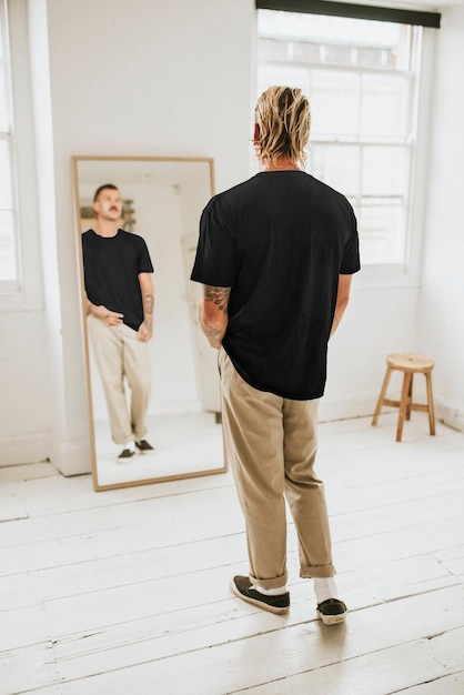 PSD mens black tee mockup psd and beige pants in front of a mirror