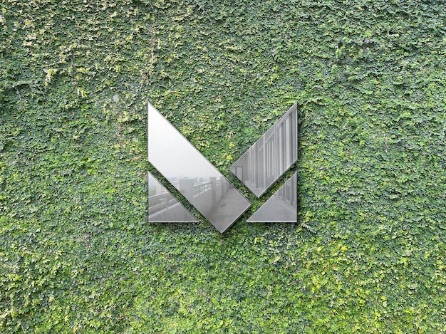 Metallic logo mockup on grass wall