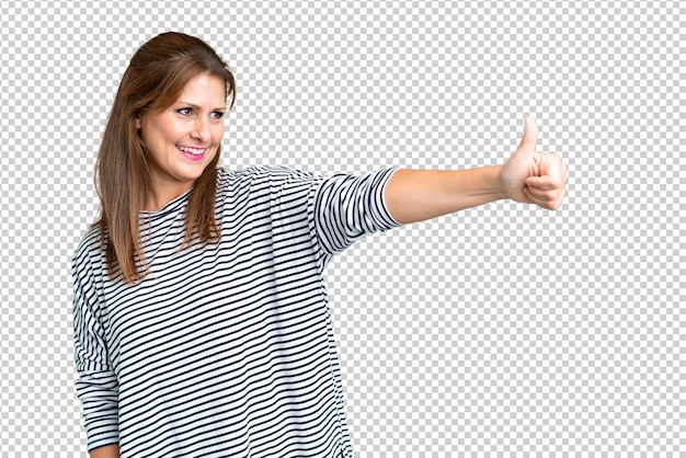 Middle age woman over isolated background giving a thumbs up gesture