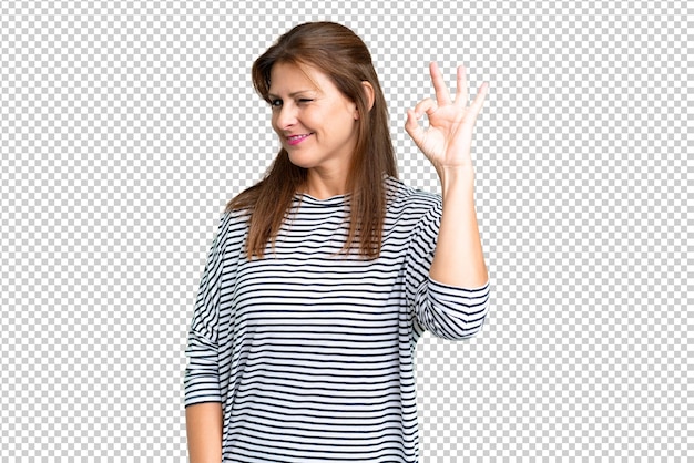 Middle age woman over isolated background showing ok sign with fingers