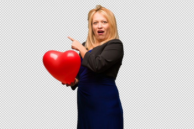 PSD middle aged latin woman celebrating valentines day pointing to the side