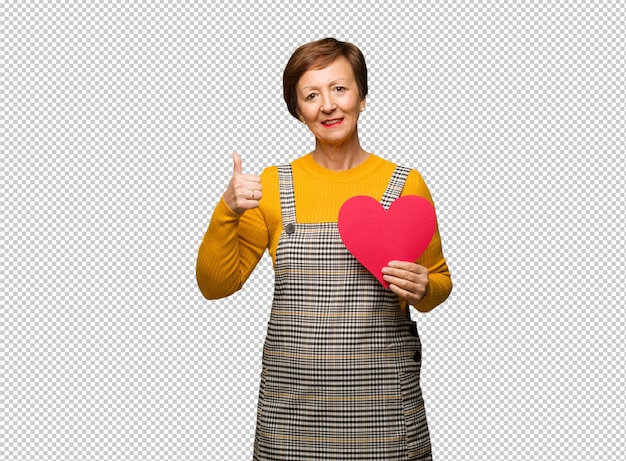 Middle aged woman celebrating valentines day smiling and raising thumb up