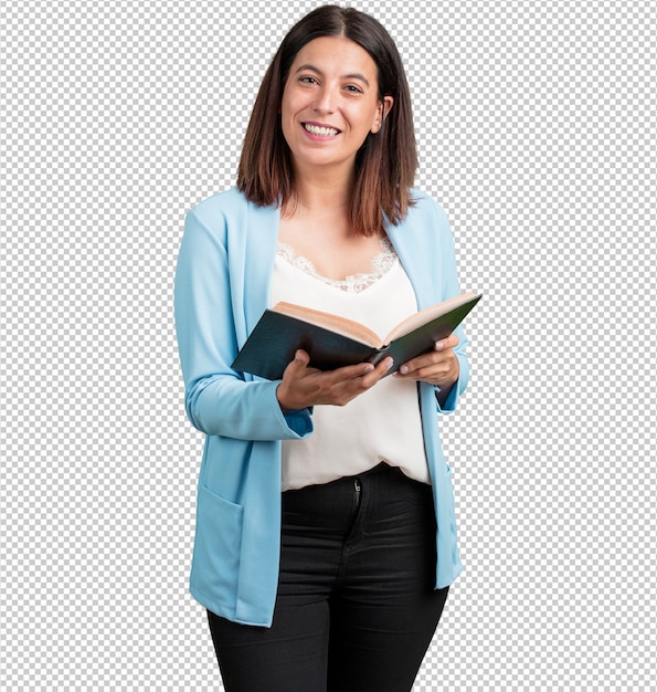 Middle aged woman concentrated and smiling, holding a textbook, studying to pass an exam or reading an interesting book