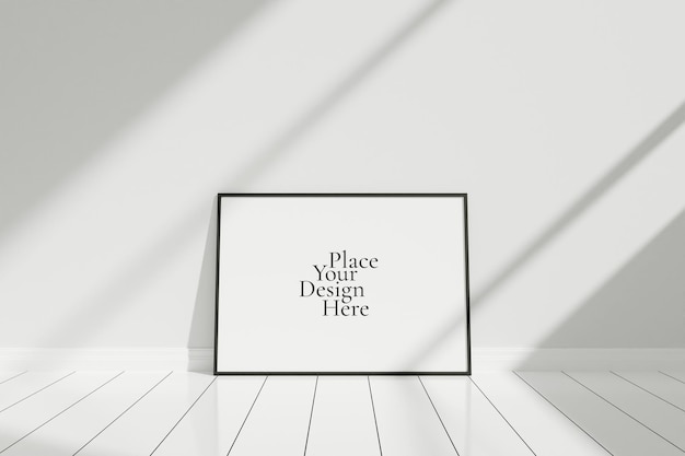 Minimalist and clean horizontal black poster or photo frame mockup on the floor leaning against the room wall with shadow