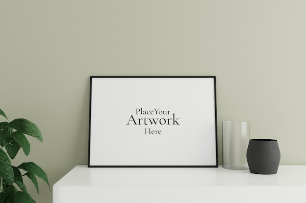 Minimalist and clean horizontal black poster or photo frame mockup on the white table leaning against the room wall with vase and plant