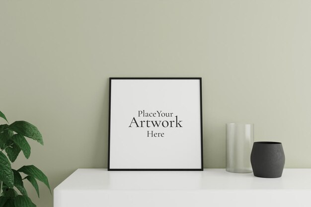 Minimalist and clean square black poster or photo frame mockup on the white table leaning against the room wall with vase and plant