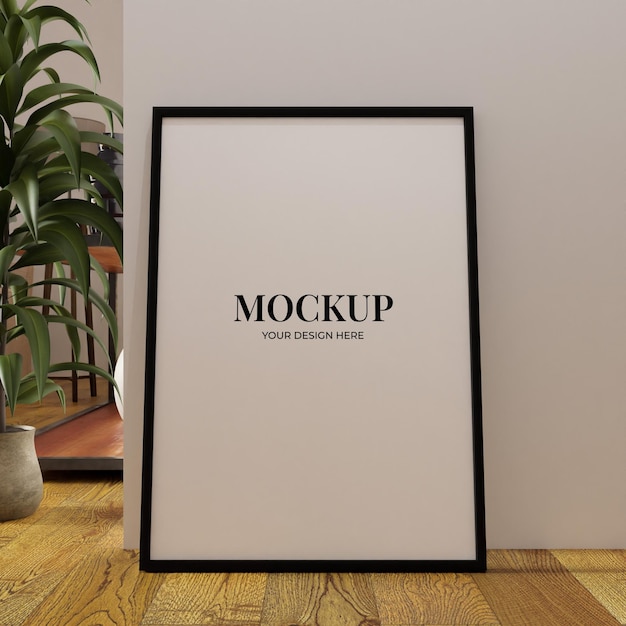 Minimalist frame mockup poster on the floor leaning on the white wall with plant as a decoration