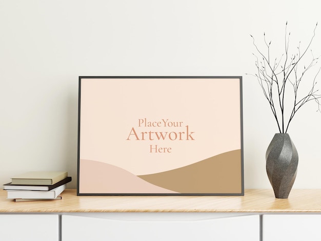 Minimalist horizontal black poster or photo frame mockup on wood table with books and vase in a room