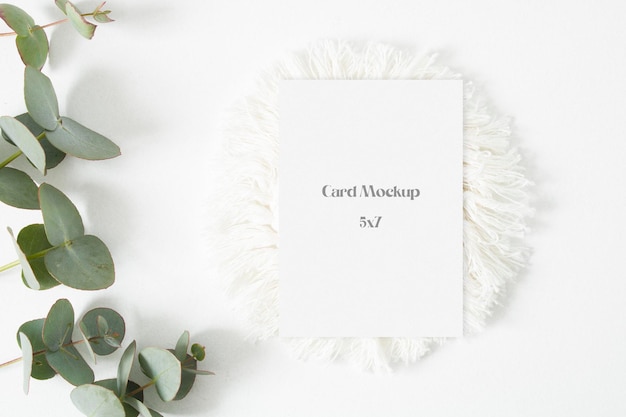 Minimalist wedding mockup card with eucalyptus leaves on the white background