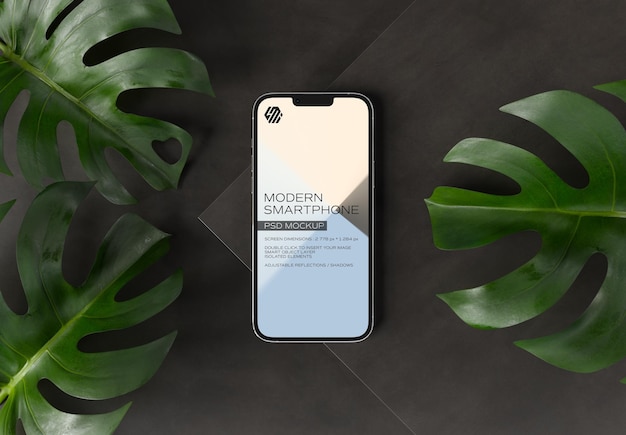 Mobile phone on black concrete display with leaves Mockup