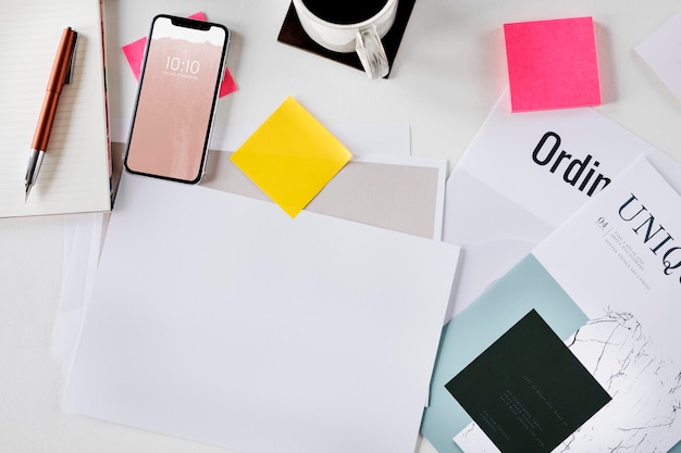 PSD mobile phone on a desk with a paper mockup