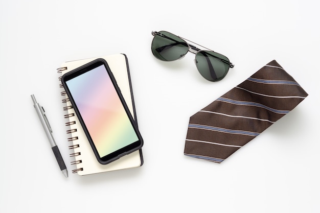 Mobile phone mockup smartphone with gentleman accessories on white desk table.