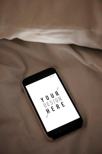 PSD mobile phone screen mockup on sheet surface