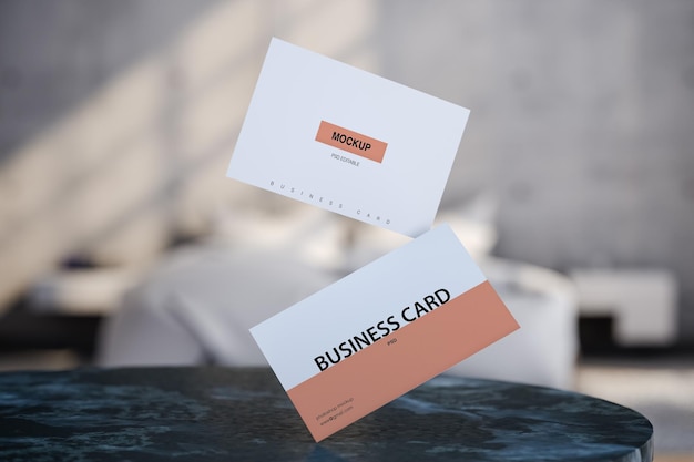 Mock Up business cards hanging over a table on blurred bedroom background. 3d render