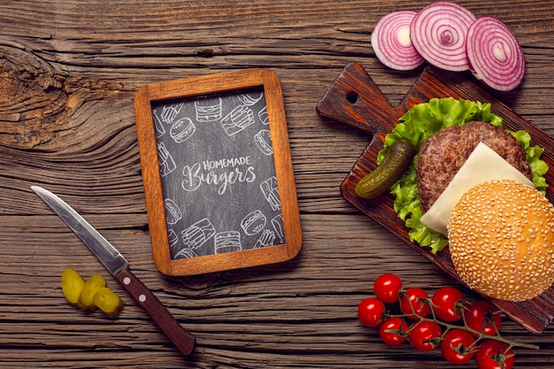 PSD mock-up chalkboard frame with burger on wooden background