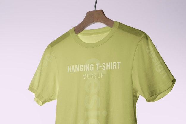 Mock-up t-shirt hanging on wooden hanger