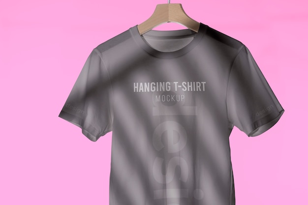 Mock-up t-shirt hanging on wooden hanger