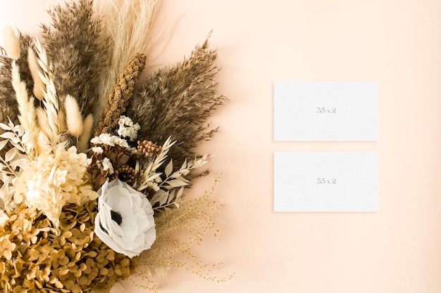 Mockup business card with dry grass leaves bouquet