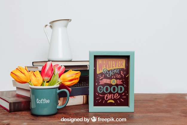 Mockup of frame next to flowers in mug