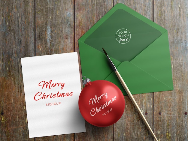 PSD mockup of holiday greeting card flyer and envelope with christmas decoration flat lay isolated