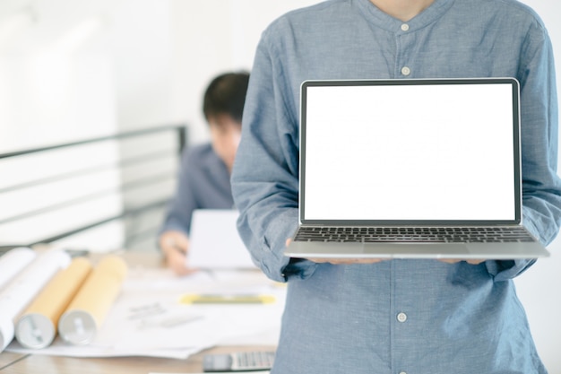 Mockup image of engineers showing laptop design building Project in office