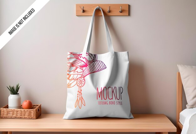 PSD mockup of a plain cotton canvas tote bag hanging on a wall hook