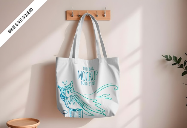 PSD mockup of a plain cotton canvas tote bag hanging on a wall hook