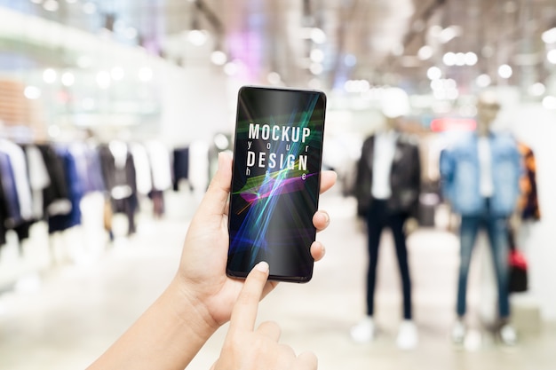 Mockup smartphone wirh blurred male clothing store