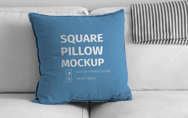 Mockup of square pillow over white sofa