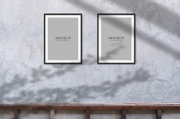 Mockup two blank photos frame on cement wall