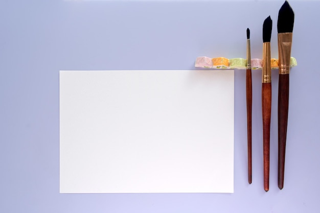 PSD mockup white paper blank watercolour painting with brushes and paints