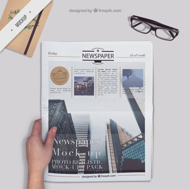 Newspaper on a desktop with agenda and glasses