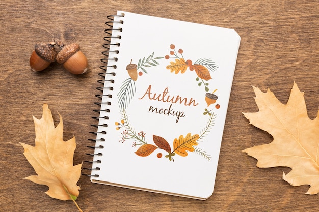 Notebook with acorns and leaves beside