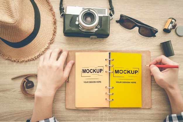 Open notebook and two female hands with pencil mockup