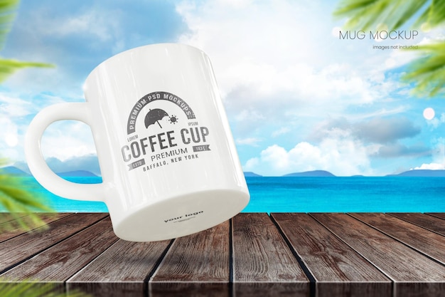 Outdoor mug mockup of 11oz cup on wooden table with beach in background