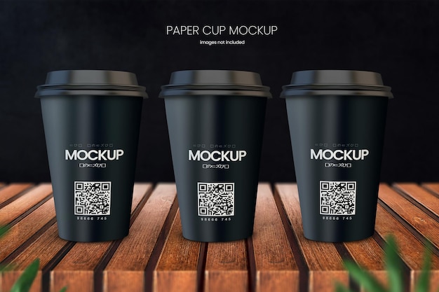 Paper coffee cup mockup of three cups on wooden tabletop with dark black in background