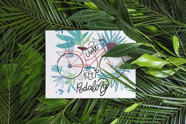 Paper mockup within tropical leaves