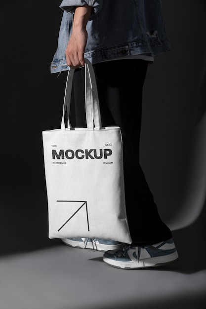 Person holding totebag mockup