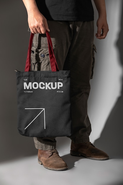 Person holding totebag mockup