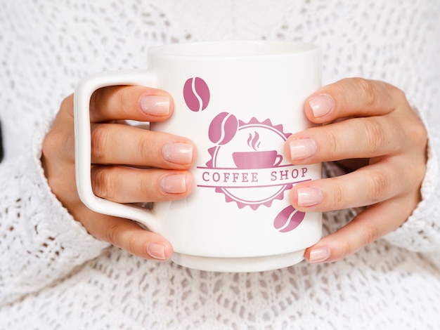 Person holding white coffee mug mock-up