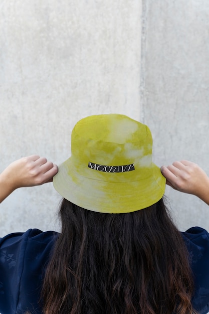 Person modeling bucket hat outdoors