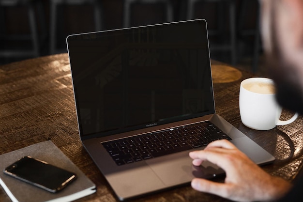 PSD a person using a laptop with a cup of coffee and a cup of coffee