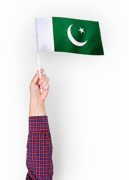 Person waving the flag of Islamic Republic of Pakistan